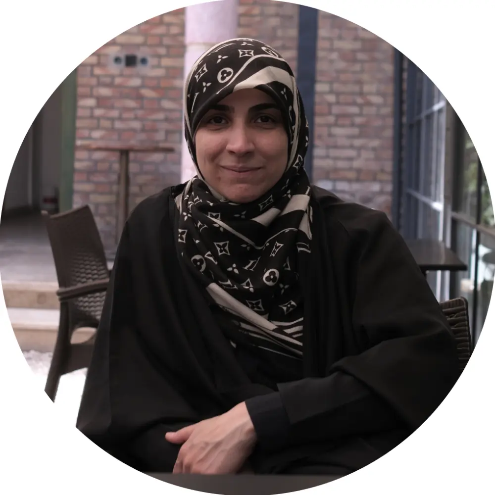 A lady siting behind a table