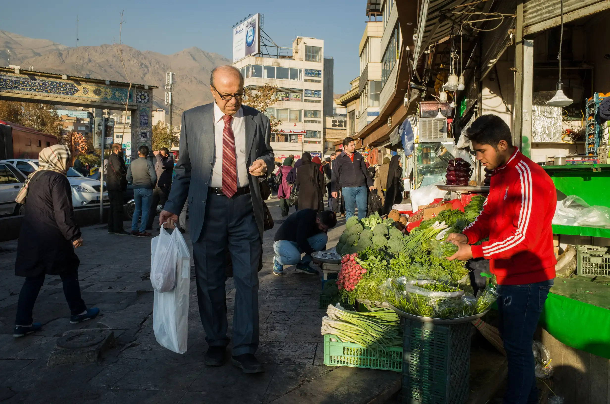 A man with a shopping bag in Tajrish